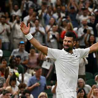 Djokovic wins longest Wimbledon quarterfinal to face Sinner