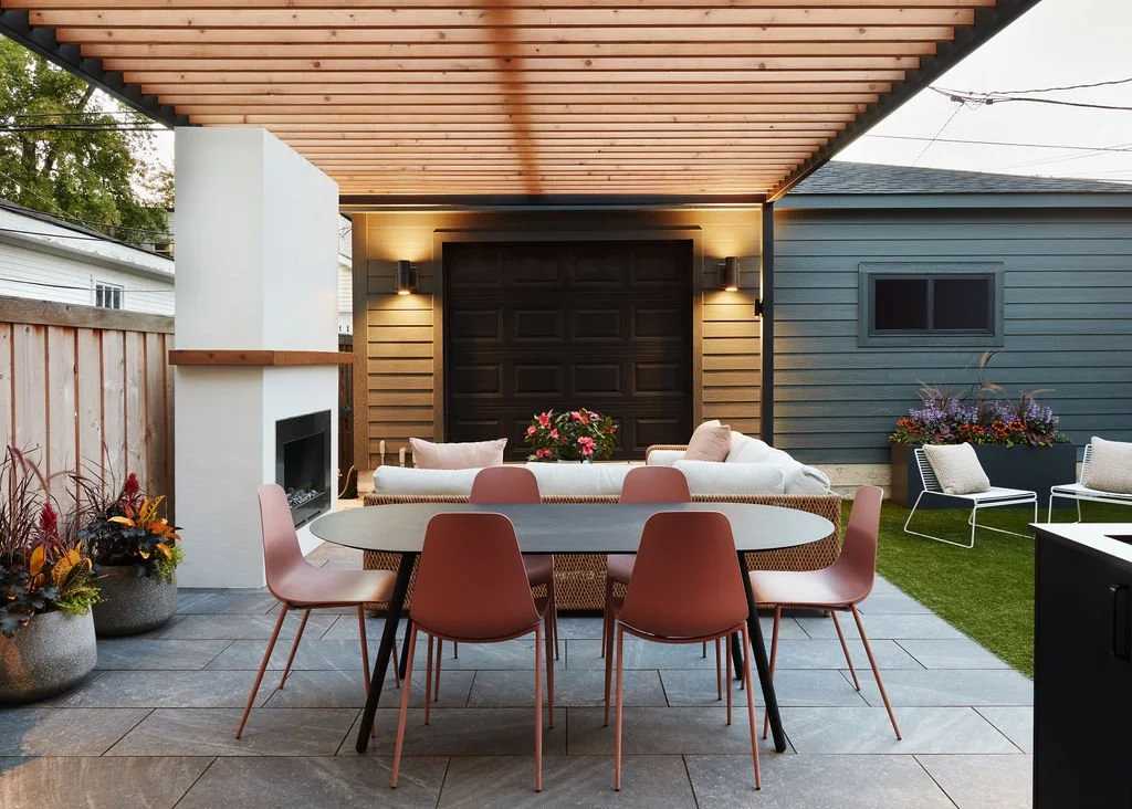 Pergola with outdoor seating and fireplace in Bay Area backyard