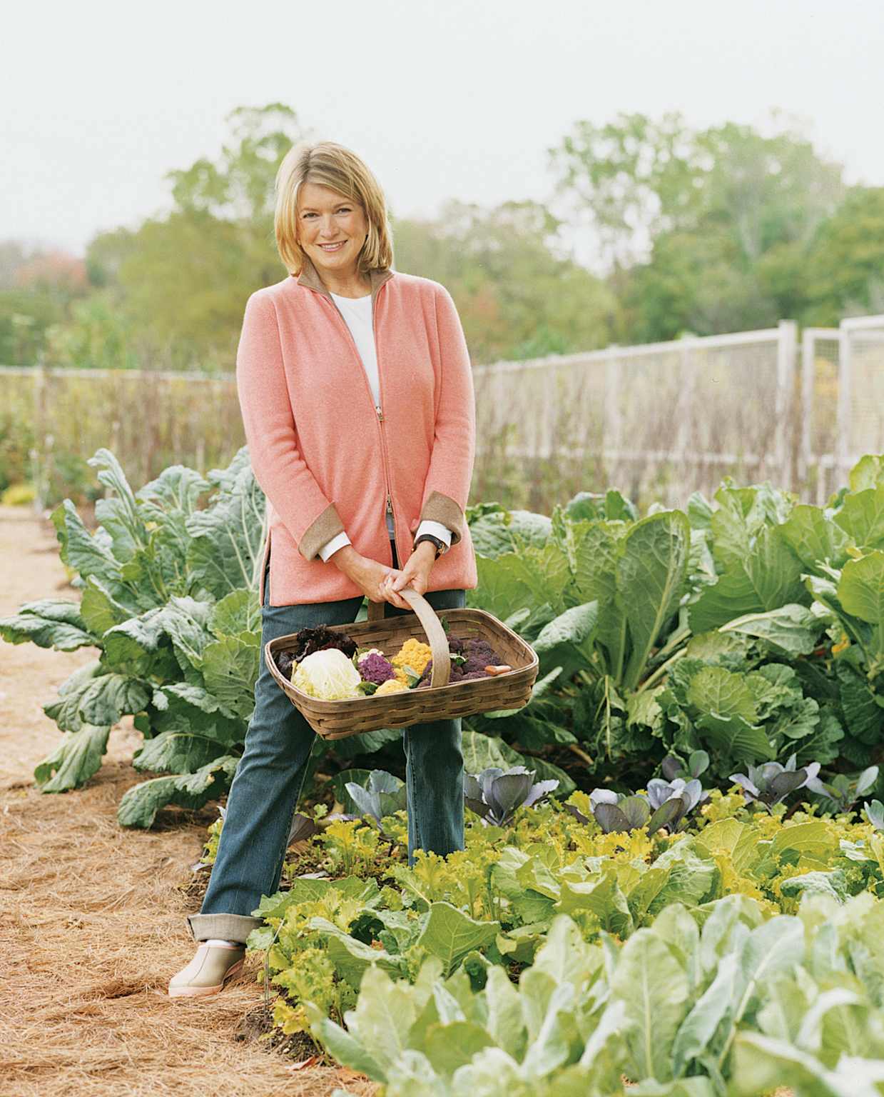 Martha Stewart with vegetables in garden