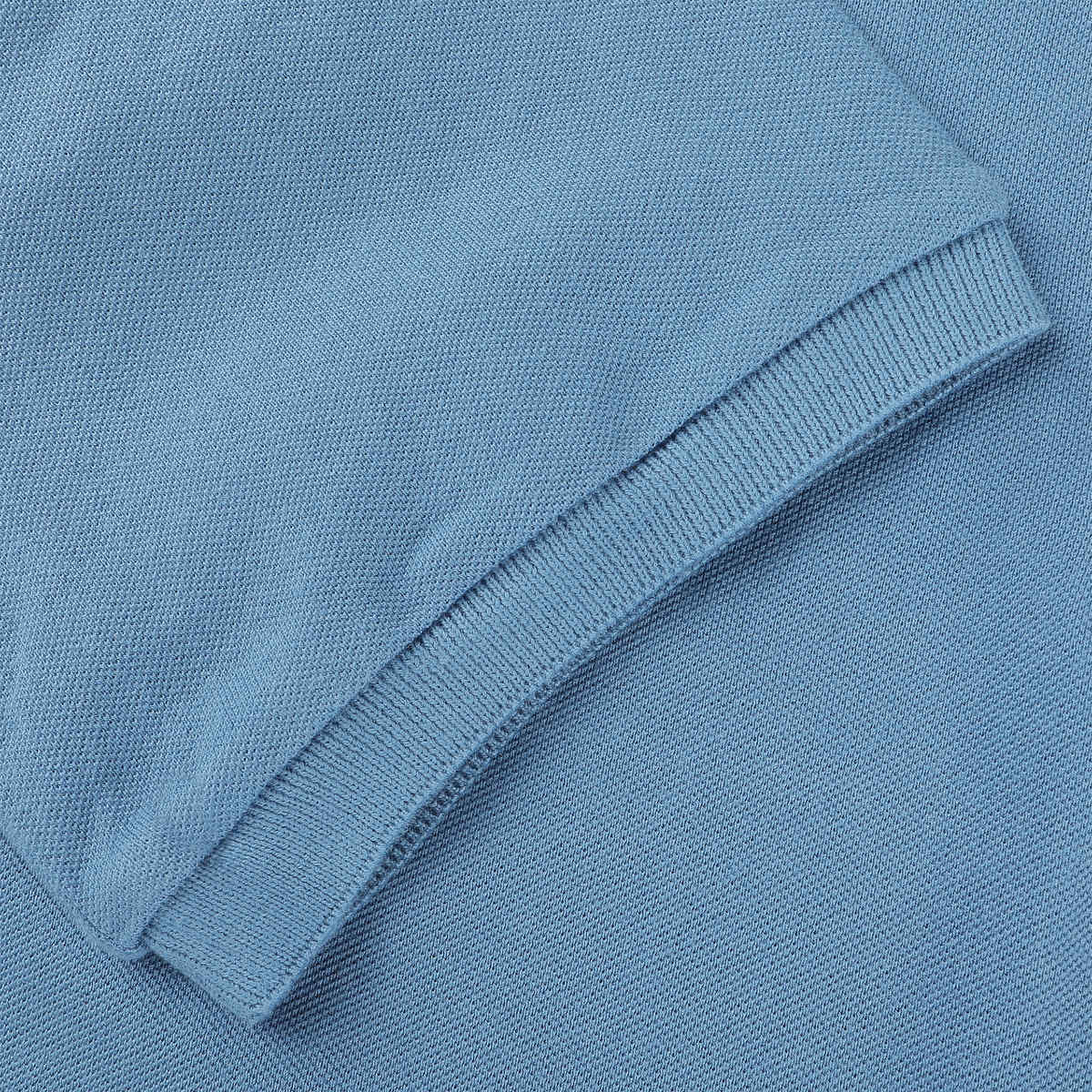 Close up of cotton pique polo t-shirt collar showing quality knit texture