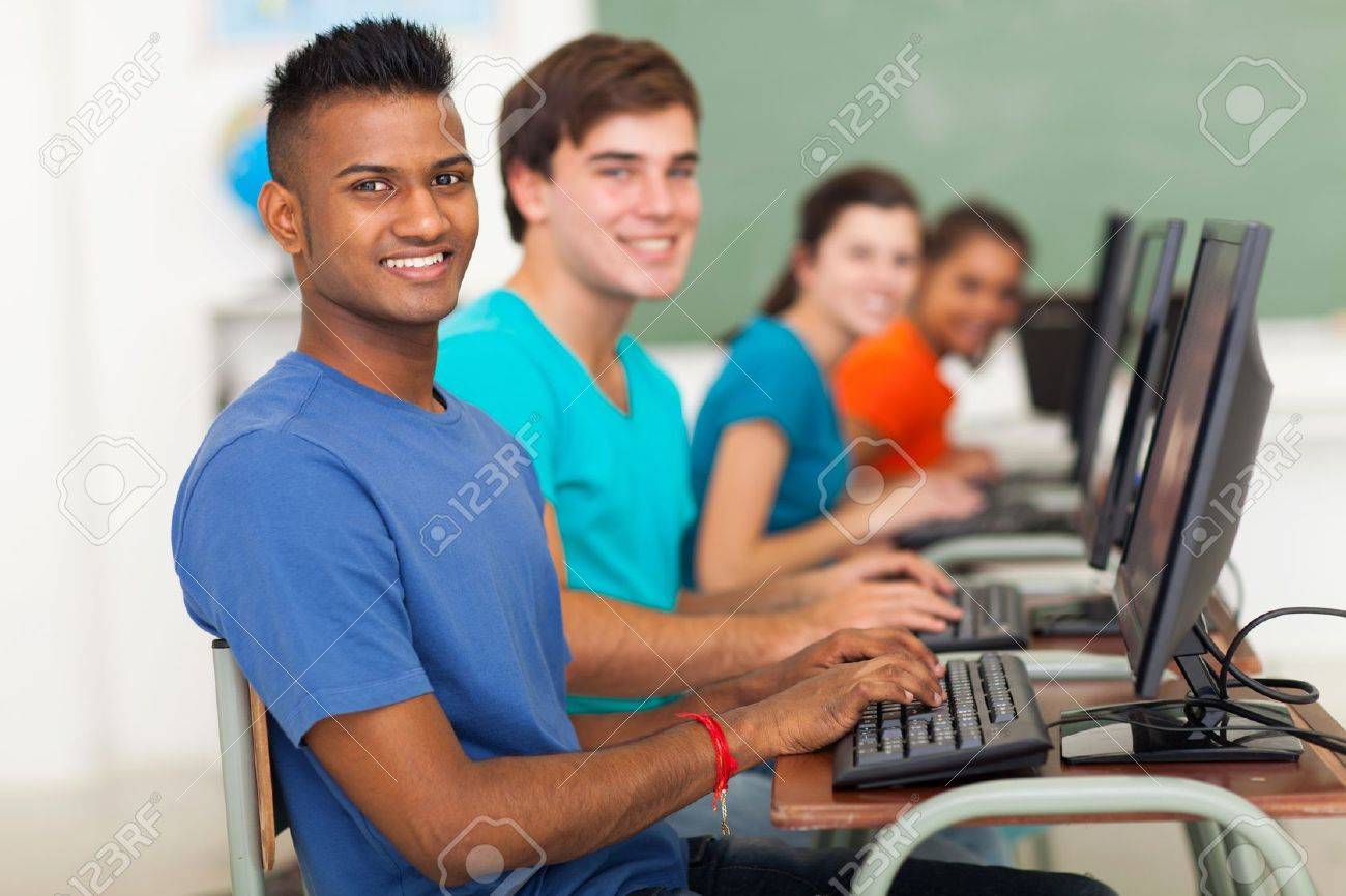 Diverse high school students using computers to learn