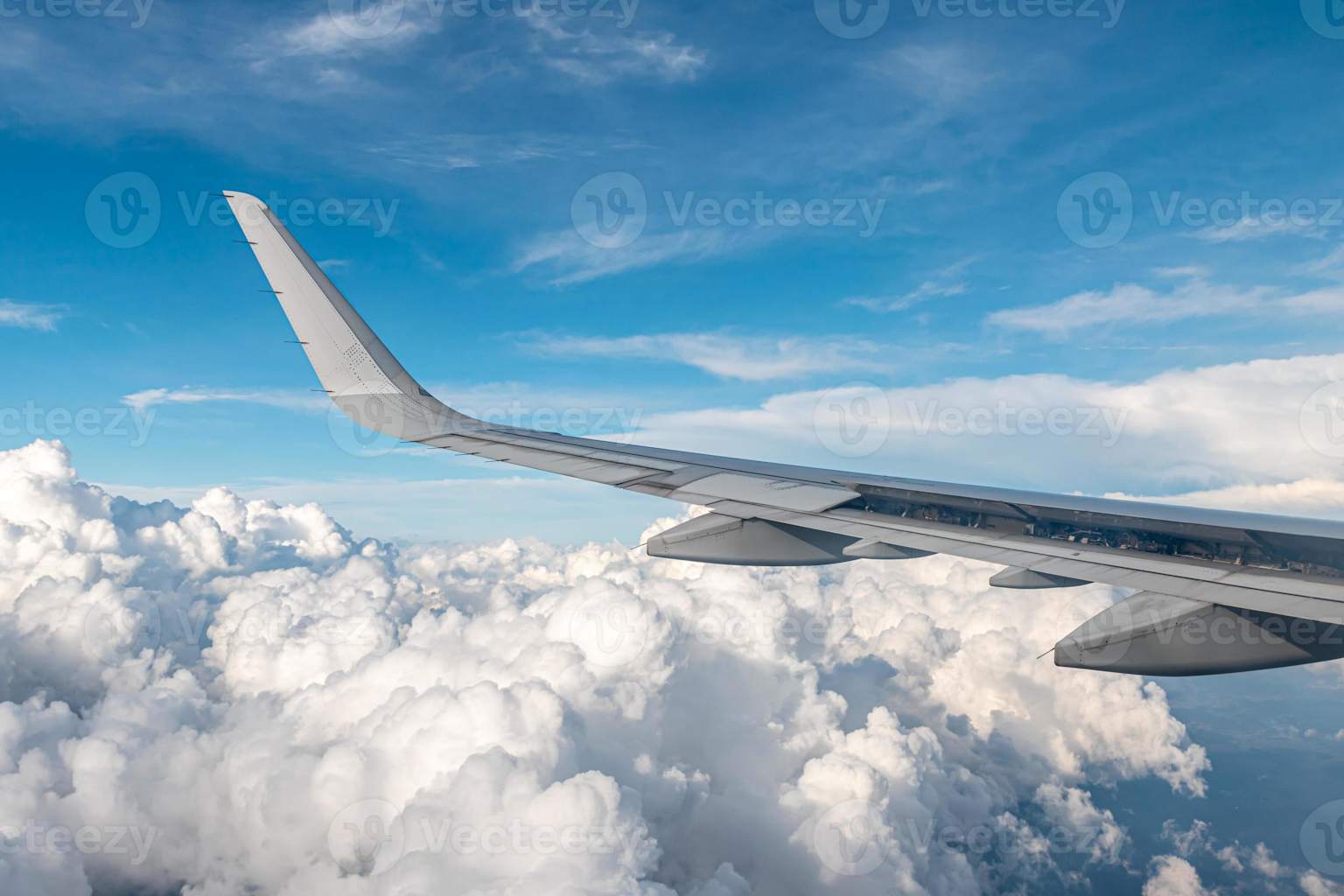 Airplane wing above clouds