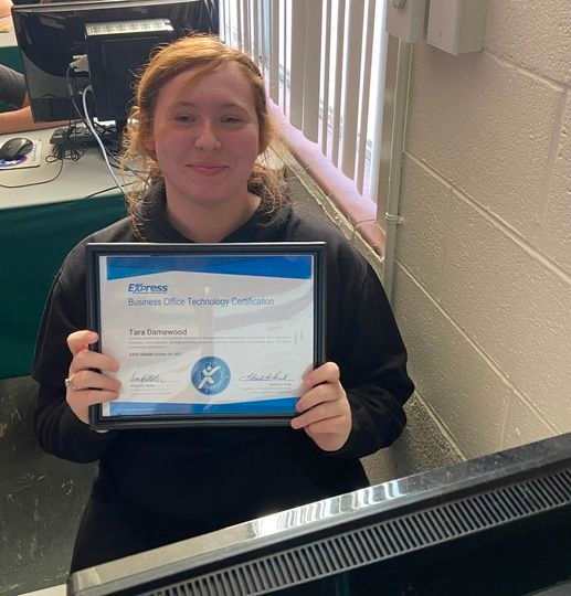 High school student holding an industry certification