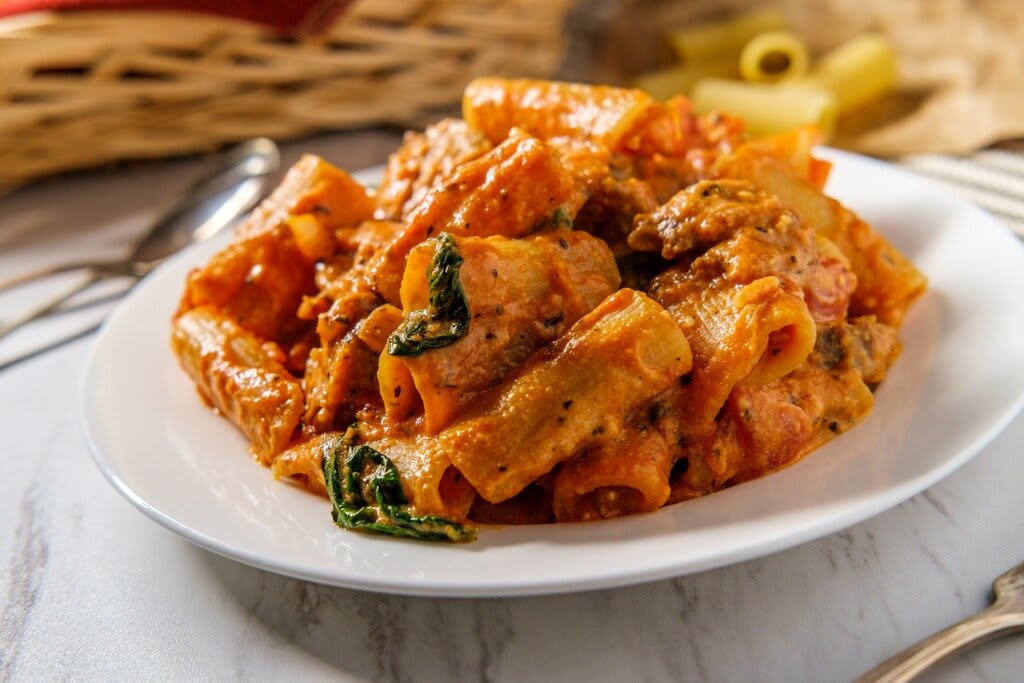 Rigatoni pasta with tomato meat sauce and basil