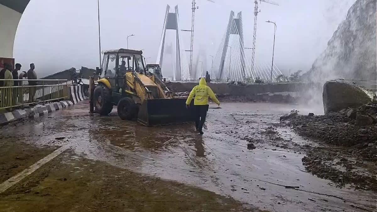 Heavy rain and mud on the Mumbai-Pune Expressway as machinery works near a landslide-hit stretch
