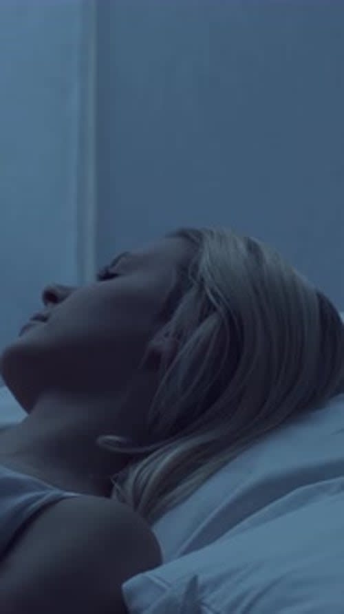 Sleep Apnea in Women: Overlooked Symptoms You Shouldn't Ignore 1 sleep apnea in women โ woman sleeping in dark bedroom showing typical OSA environment