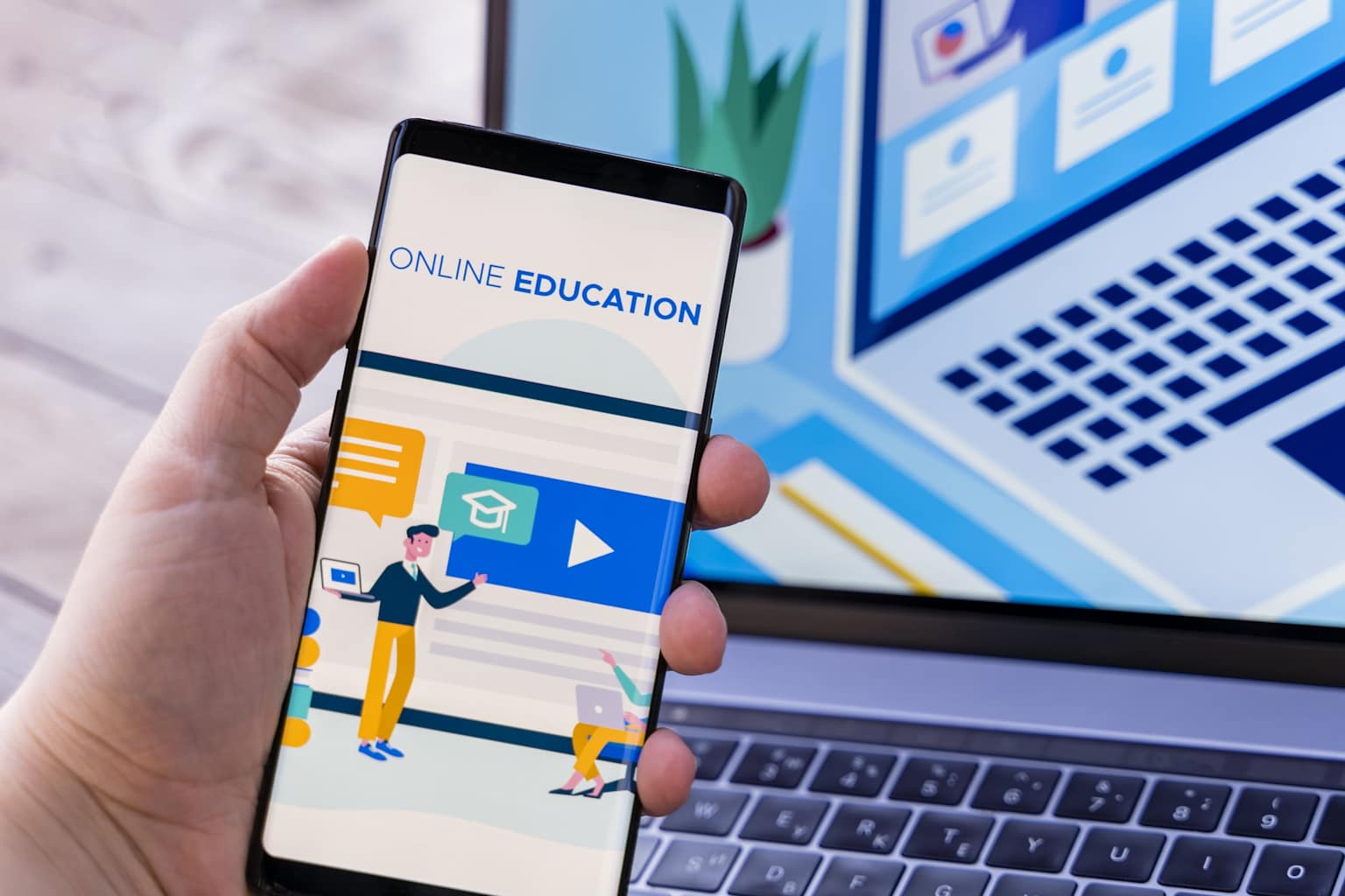A hand holding a smartphone displaying an online education interface — mobile learning at your fingertips