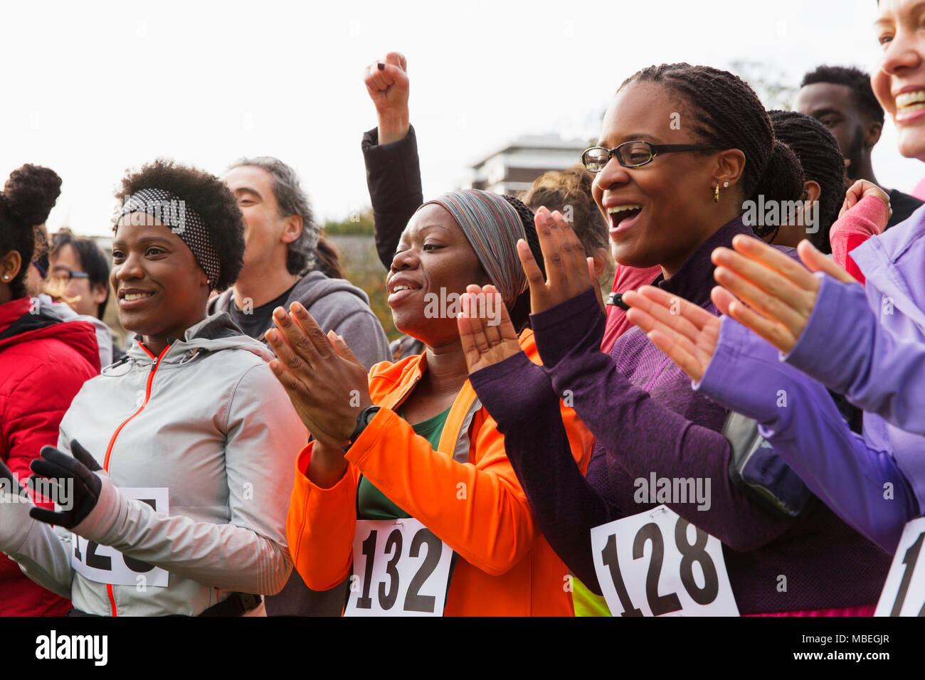 Crowd cheering runners at a race event