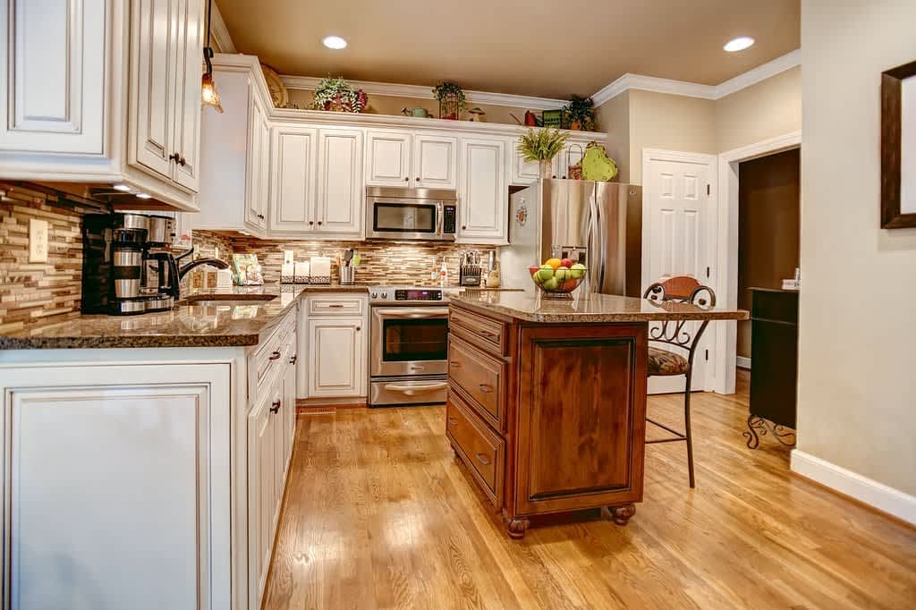 Free cabinet refacing consultation — our cabinet refacing contractor assessing kitchen cabinets