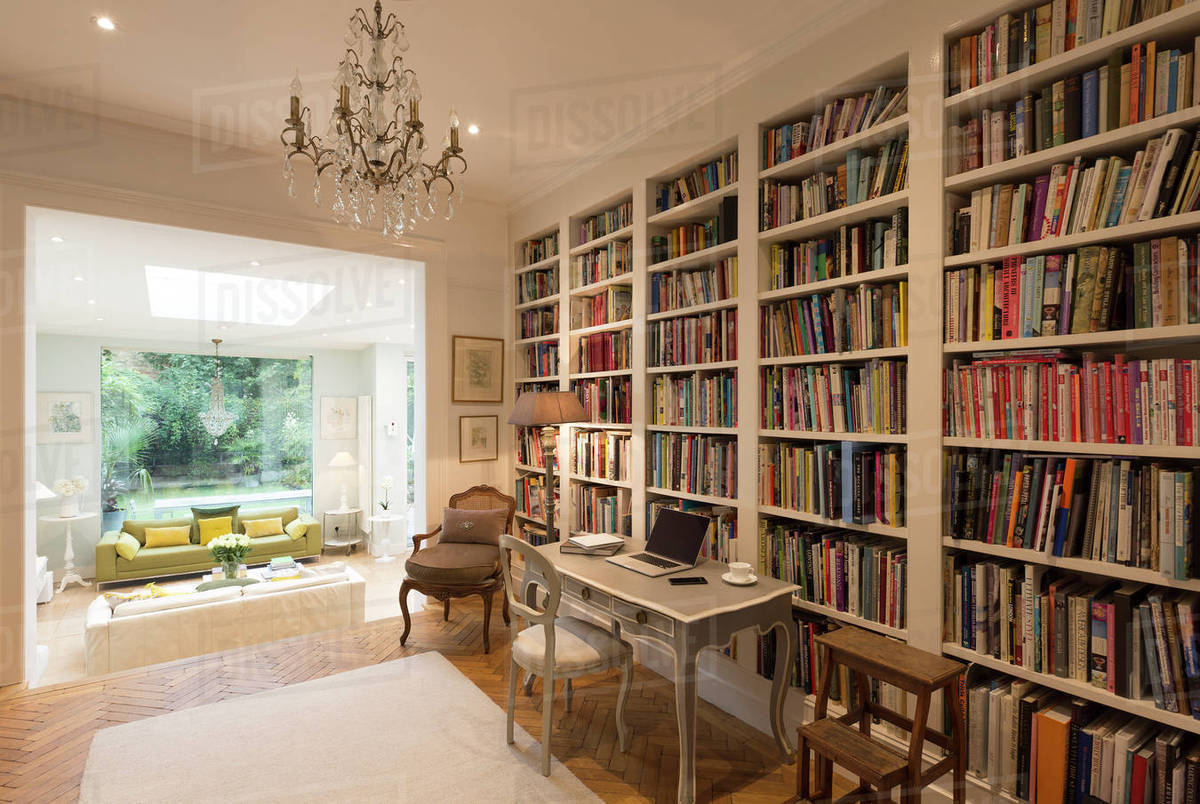 Elegant home library with bookshelves and chandelier