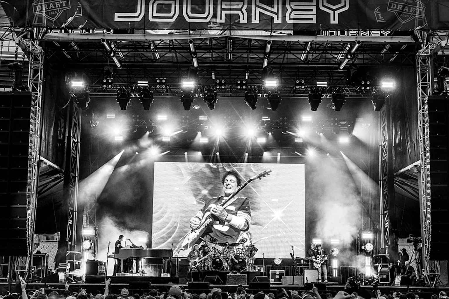 Journey performing on stage with dramatic lighting