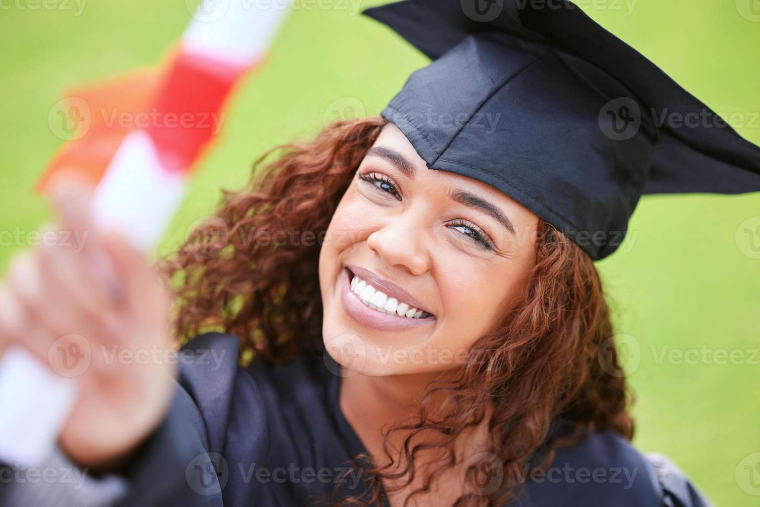 Young woman holding her diploma and smiling