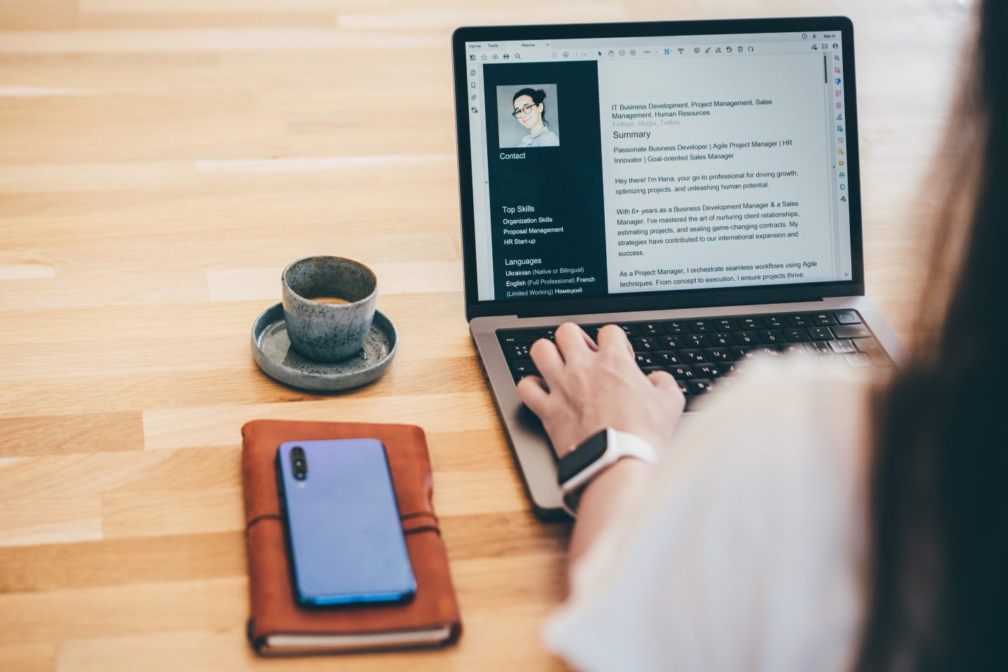 Professional resume writing process on laptop