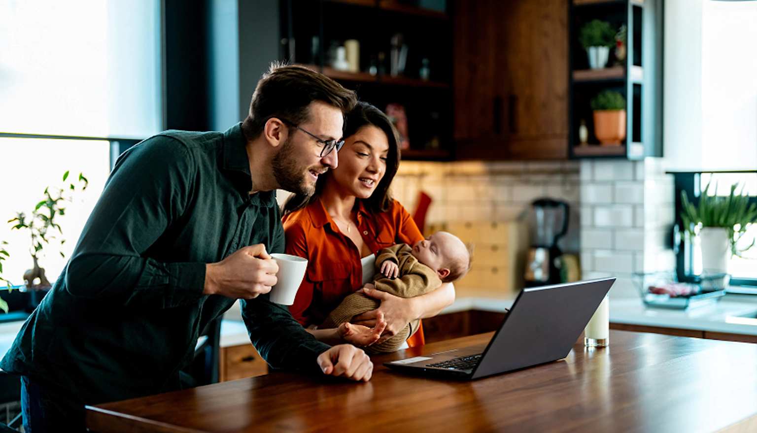 Family reviewing a home search together on a laptop