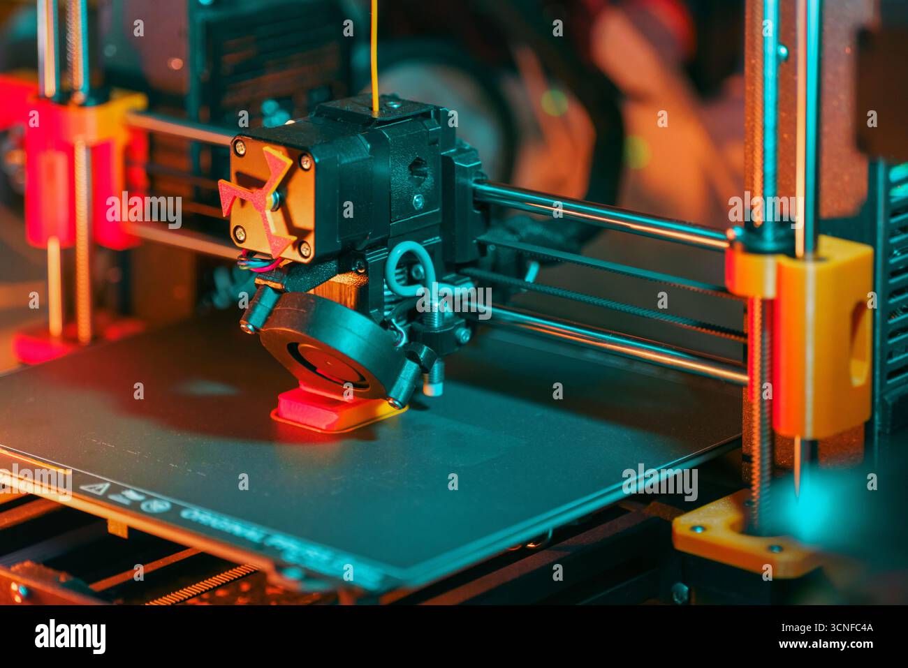 3D printer extruder printing red filament
