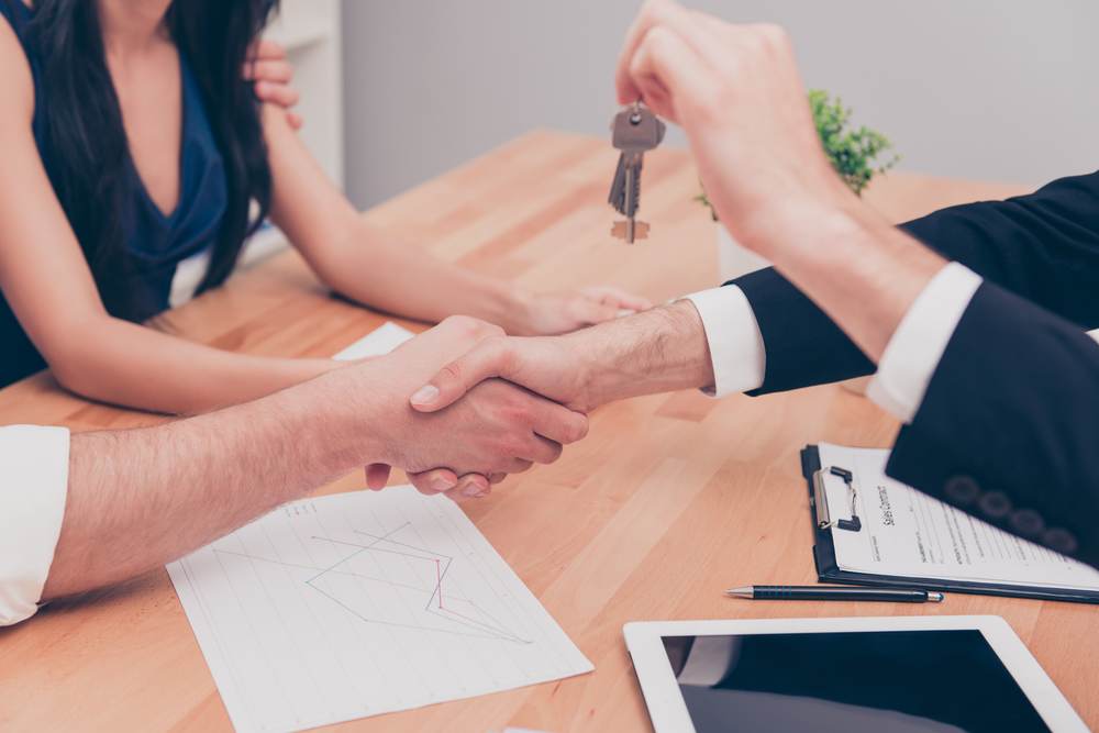 Real estate closing table with keys and documents