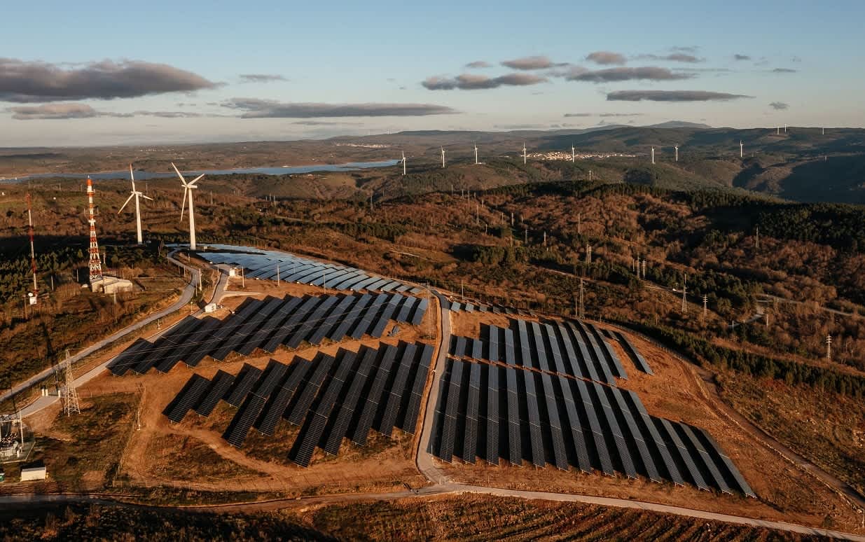 Solar PV and wind turbines in Portugal at sunset