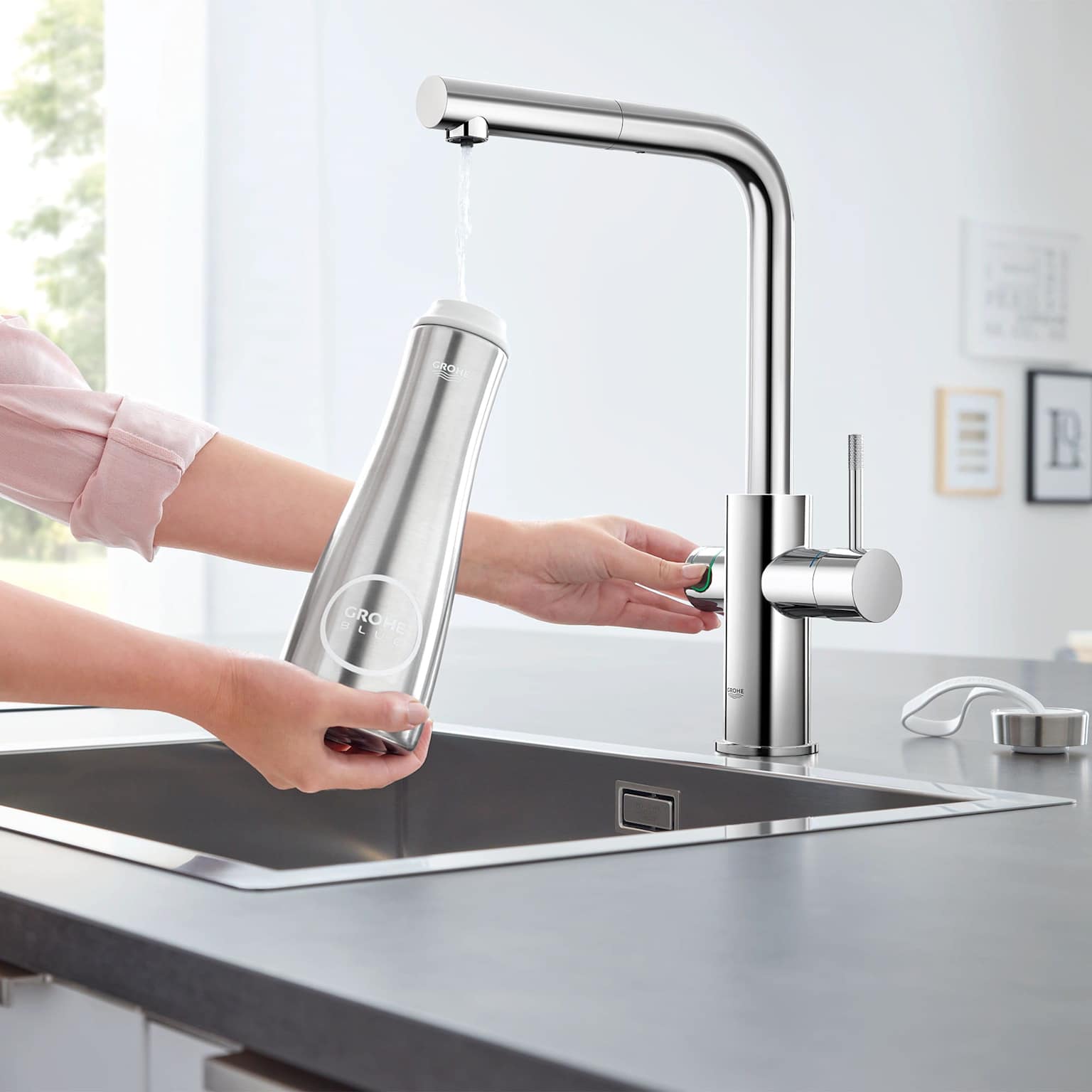 Clean filtered water pouring from a kitchen faucet filter