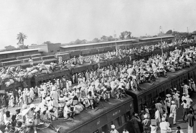 Refugees overcrowding trains during the 1947 Partition of India, one of the largest forced migrations in history.