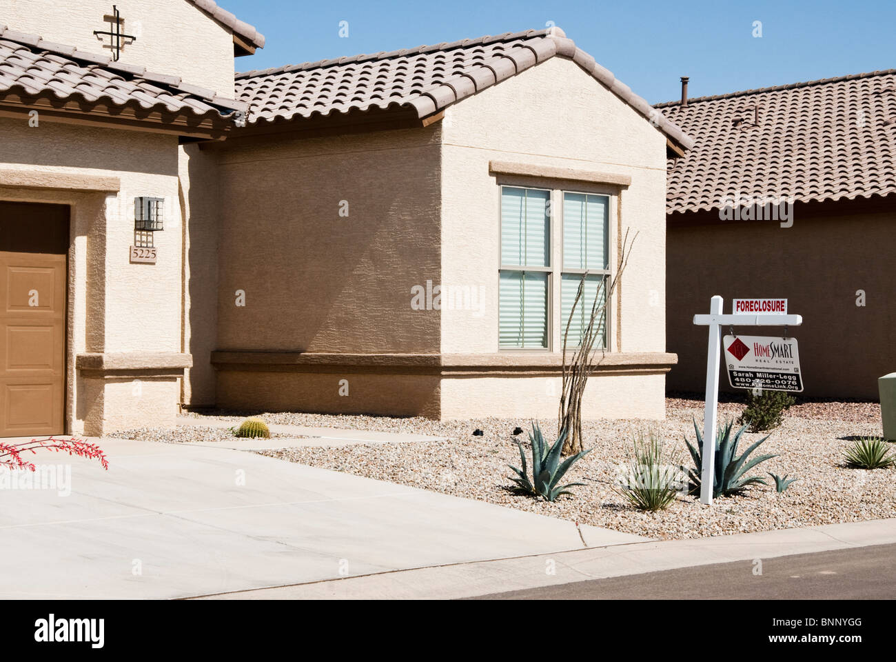 Foreclosed house with bank sale sign
