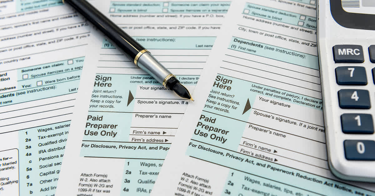 Tax forms calculator and pen for rollover guide