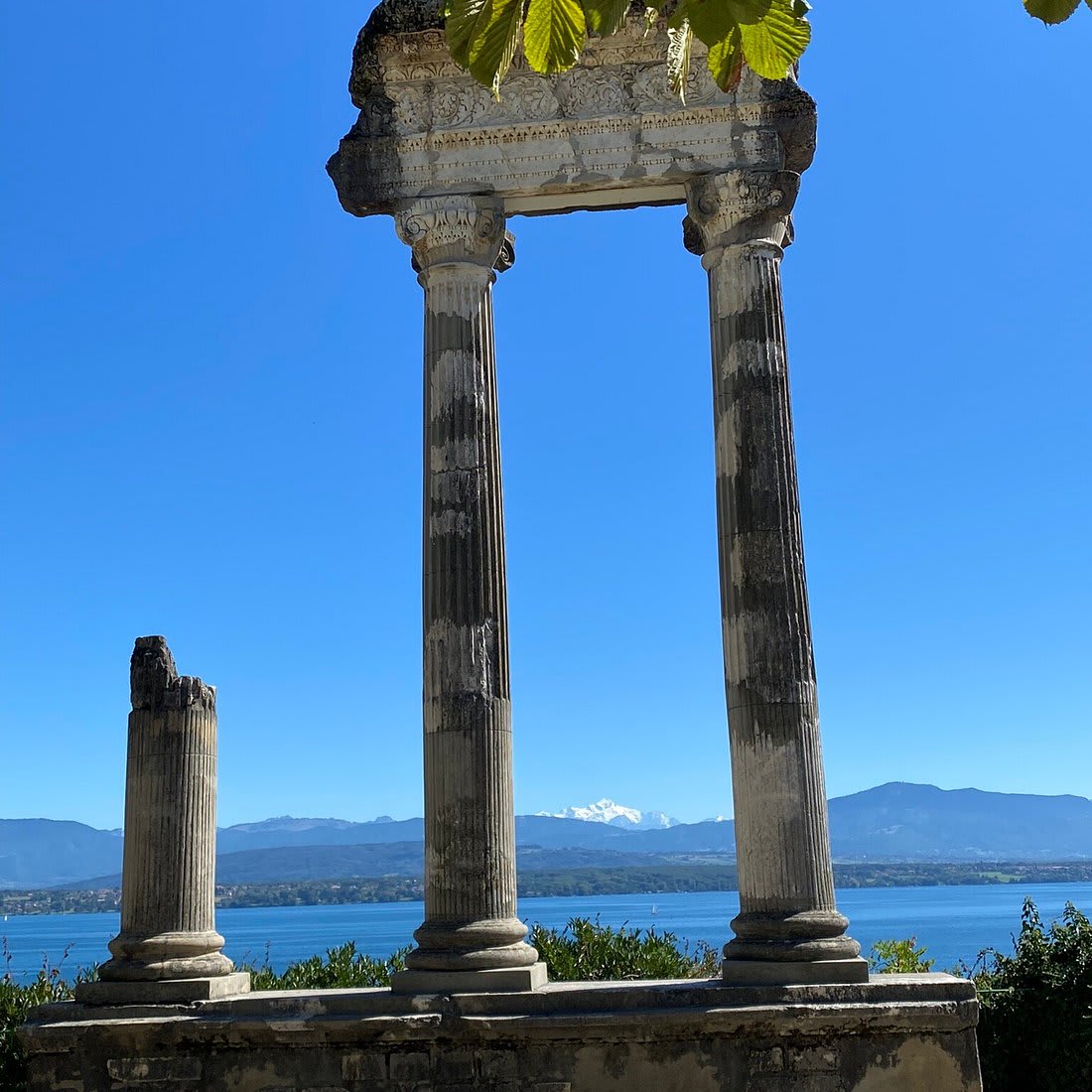 Roman arch columns overlooking Lake Geneva mountains