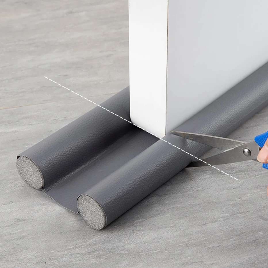 A homeowner cutting an insulated foam weather stripping seal for a drafty door