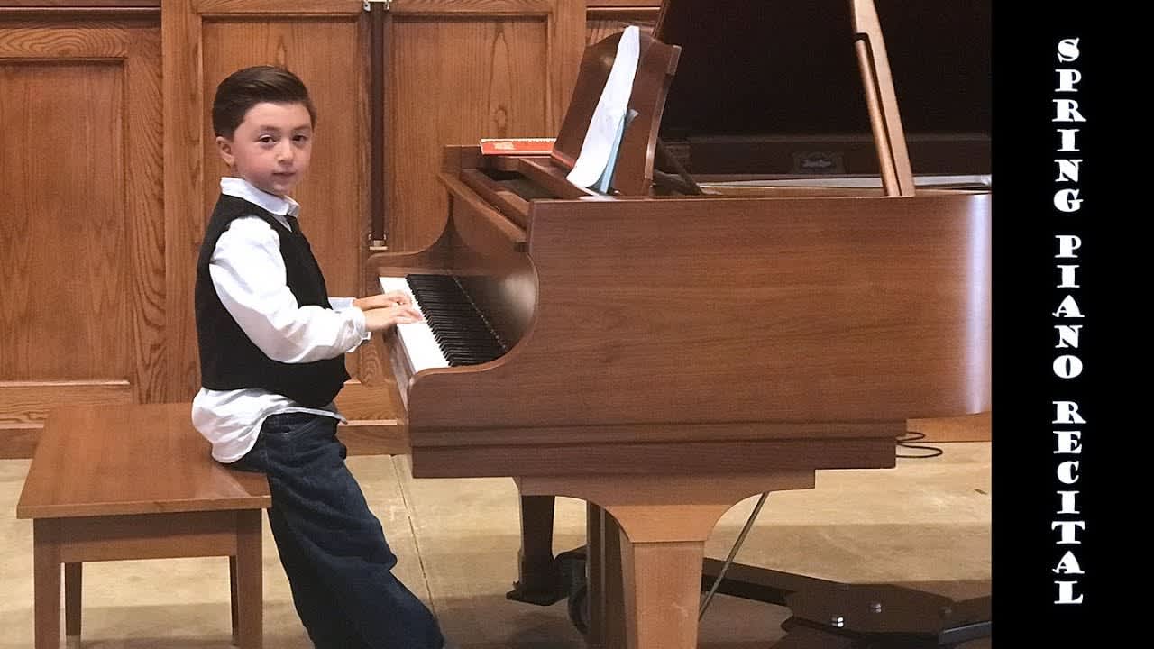 Child performing at piano recital