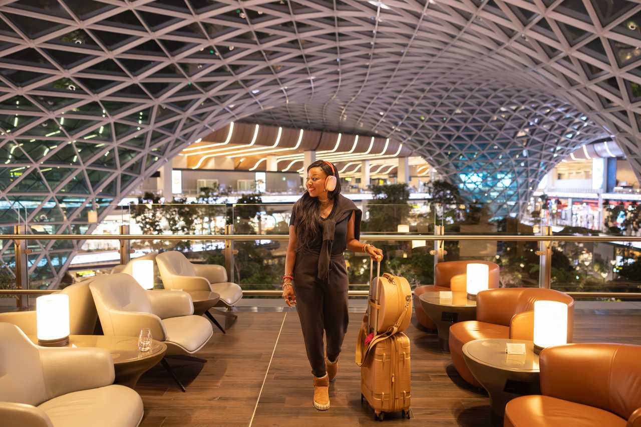 Modern airport lounge with lattice ceiling and warm lighting