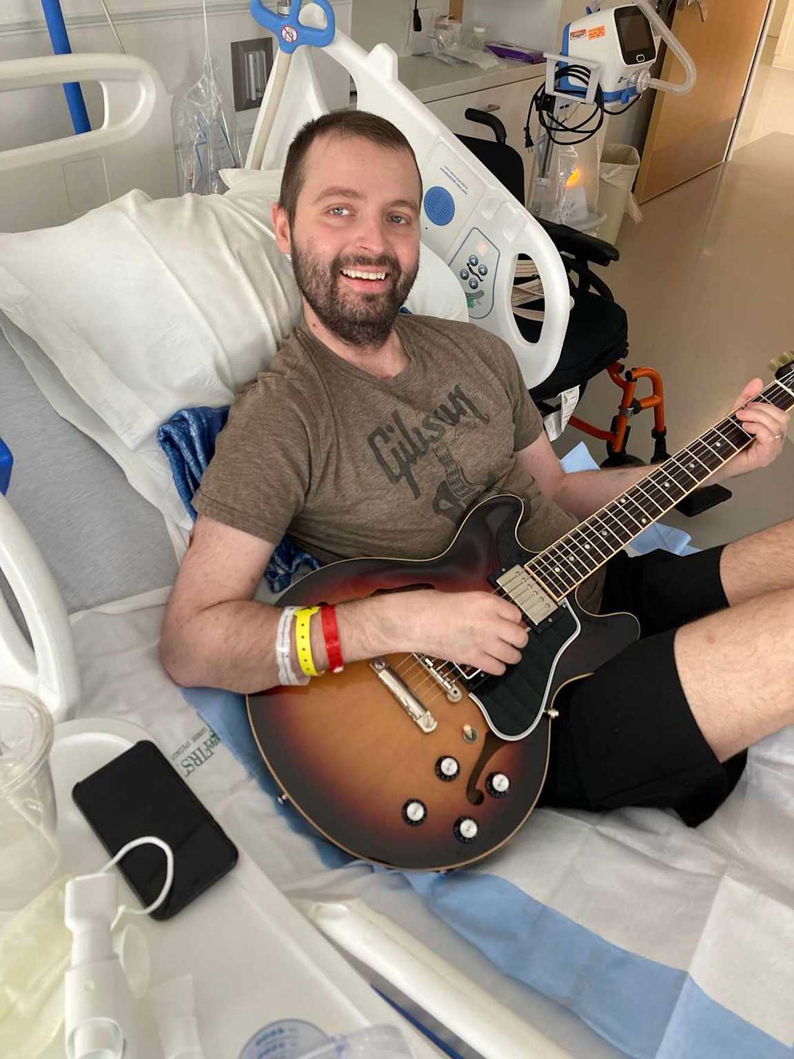 Dean playing guitar in hospital