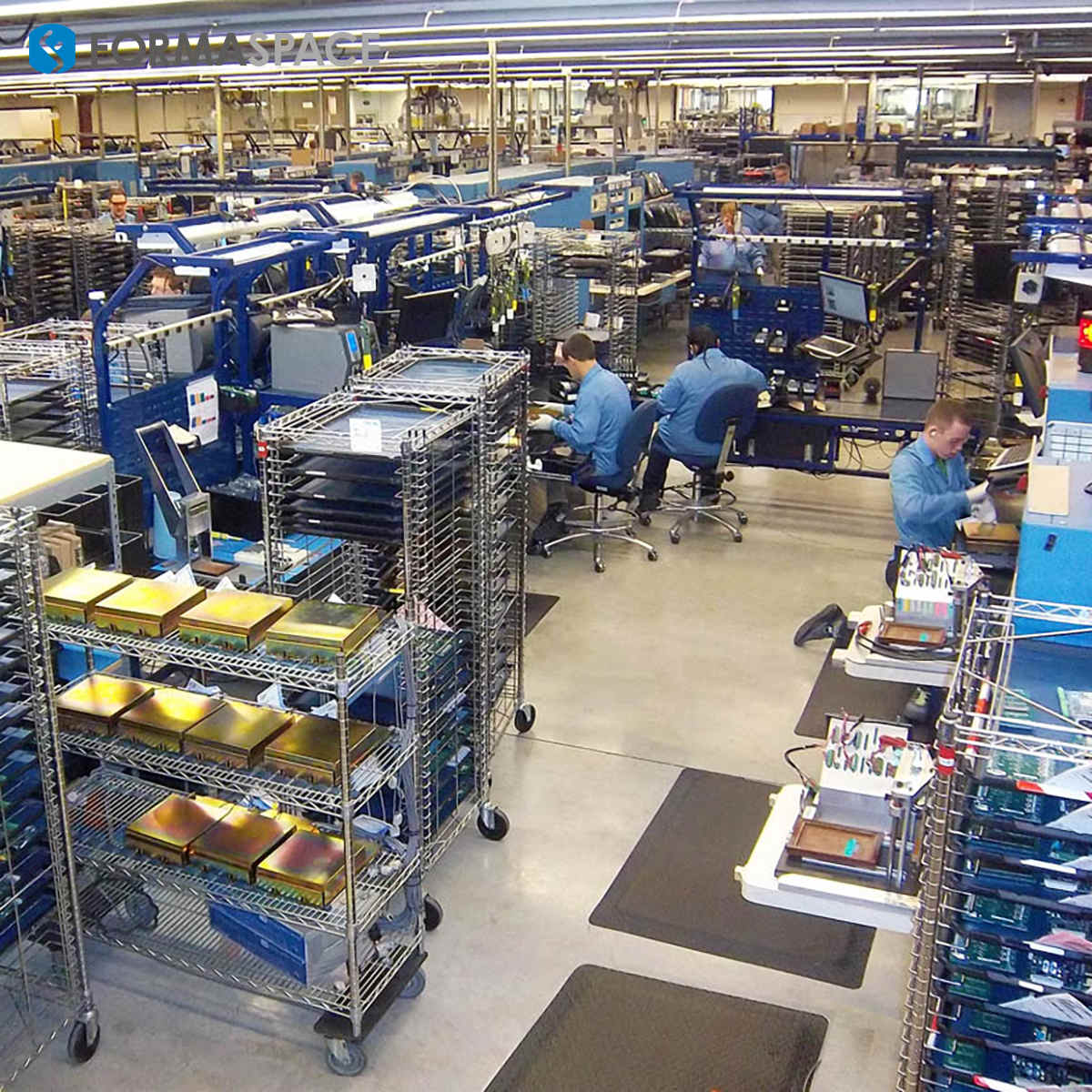 Factory worker operating machinery on a modern electronics assembly line