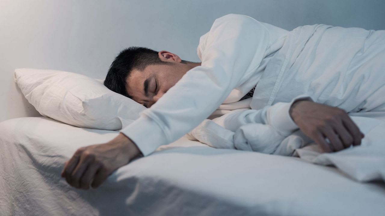 sleep paralysis — man lying unable to move in bed during an episode