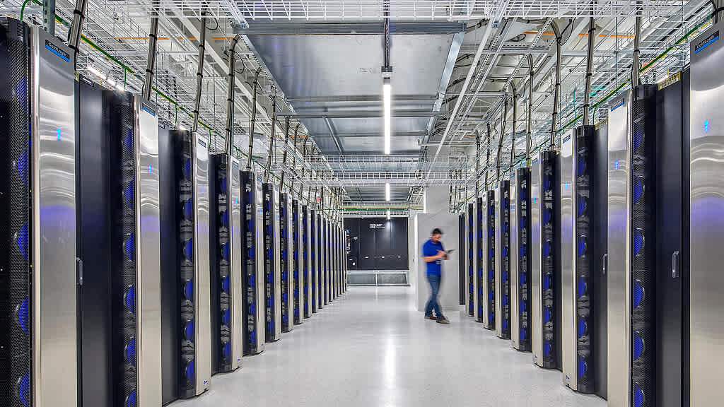 Rows of glowing blue server racks in a modern data center