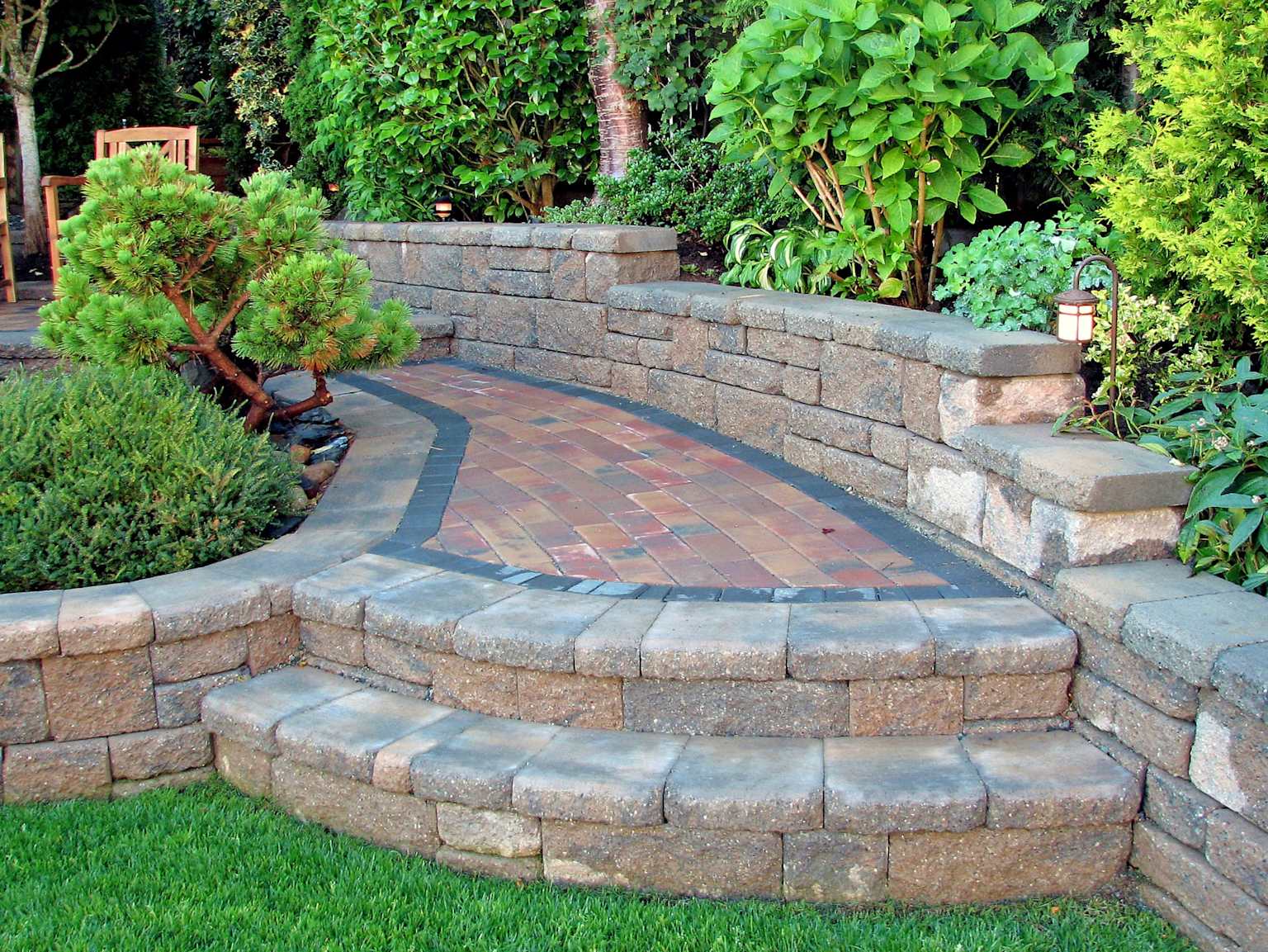 Completed retaining wall with paver pathway and garden Bay Area