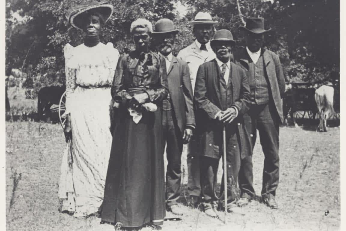 Historical black-and-white Juneteenth celebration photograph showing a group gathered outdoors.