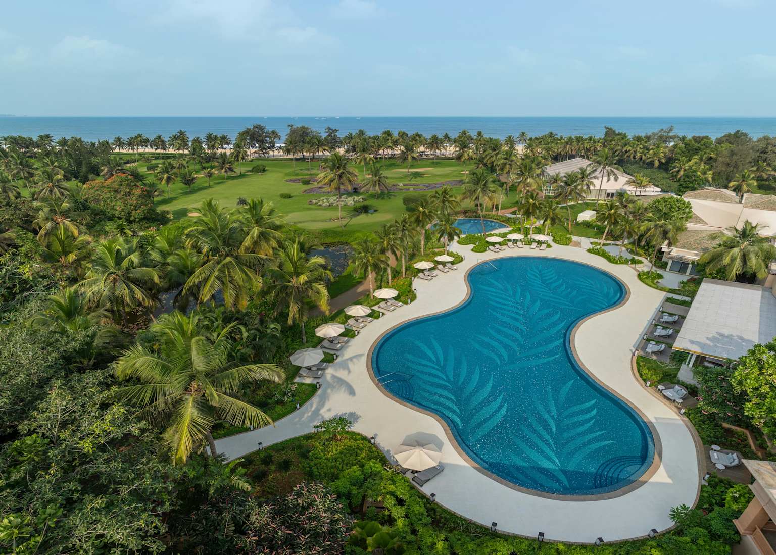 The St. Regis Goa Resort pool and gardens with ocean backdrop