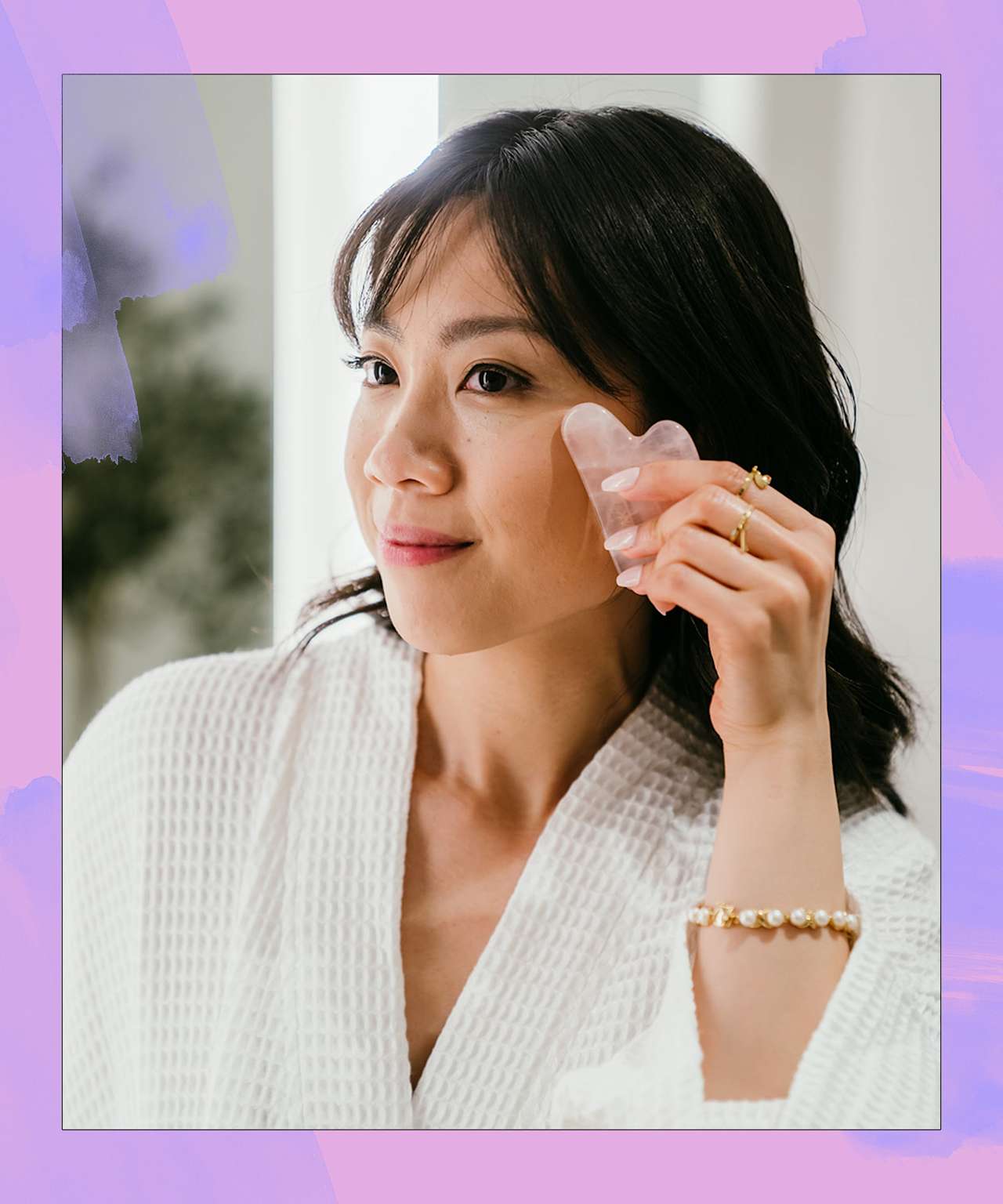 Asian woman using gua sha tool