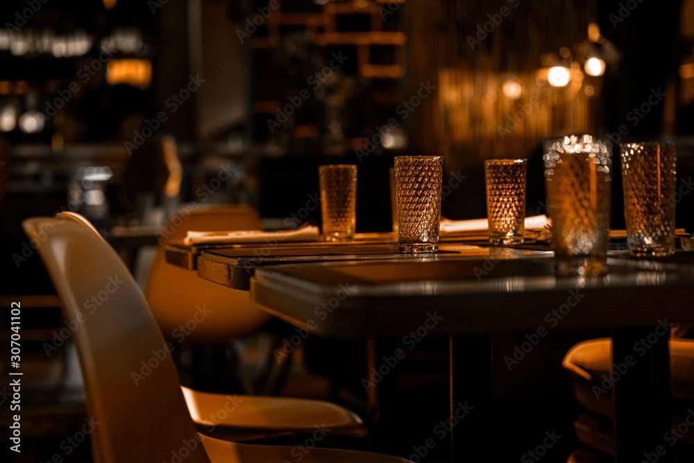 Cozy restaurant table with warm lighting and glassware