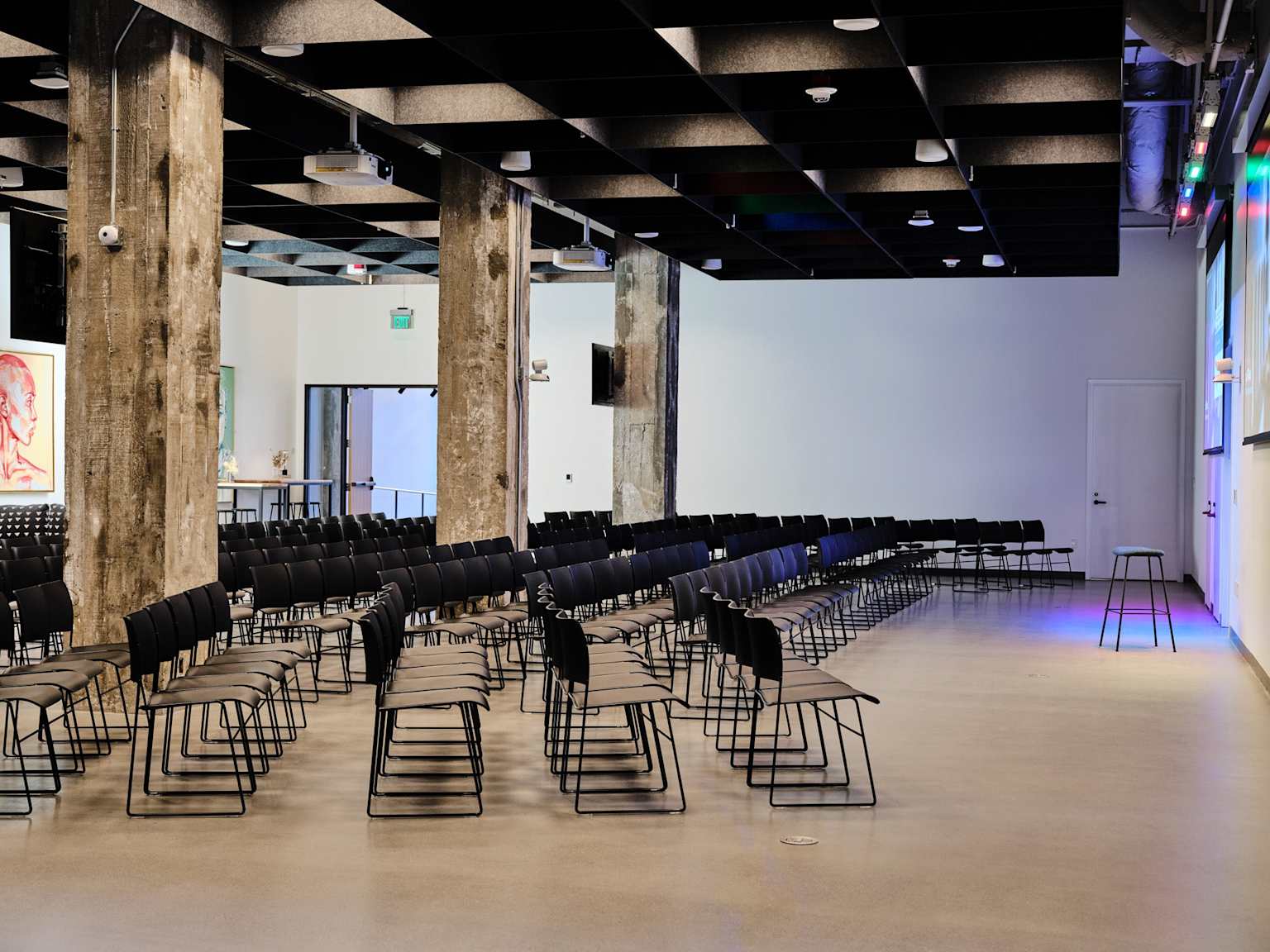 Community event space with rows of chairs and modern lighting