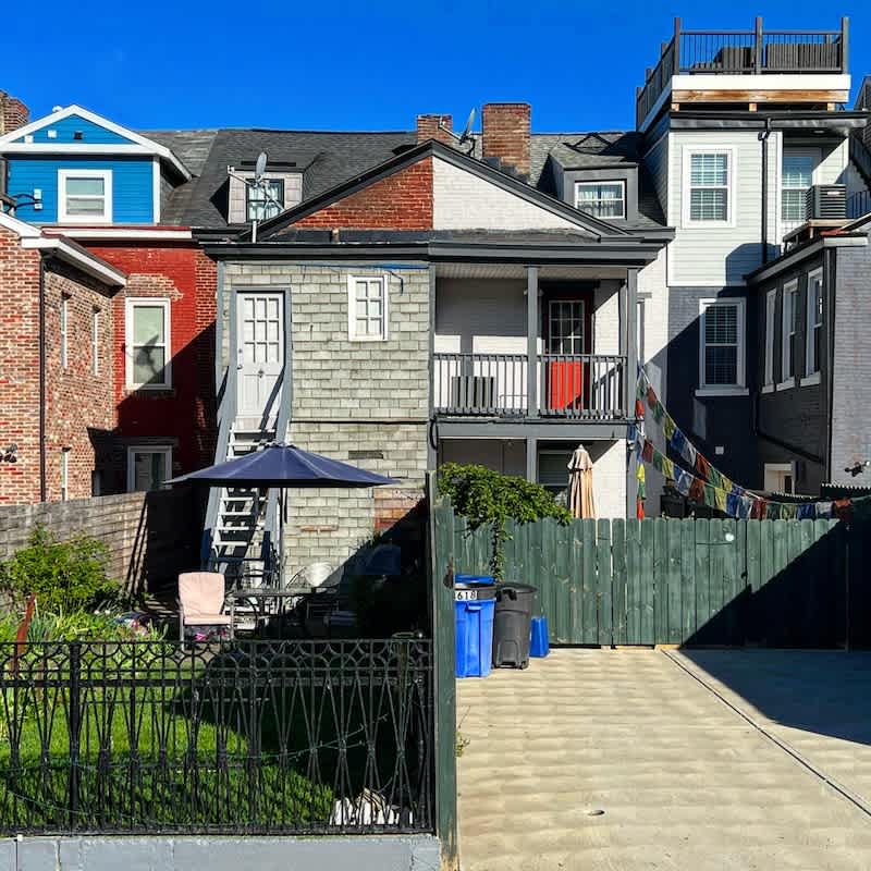 Pittsburgh row houses undergoing renovation with brick and colorful exteriors
