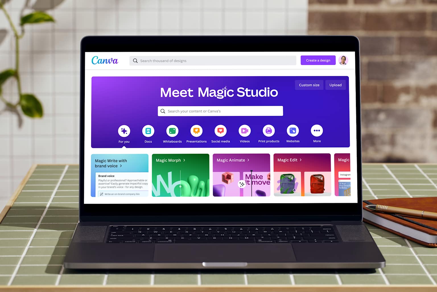 Laptop displaying the Canva design platform website with design tools and templates visible
