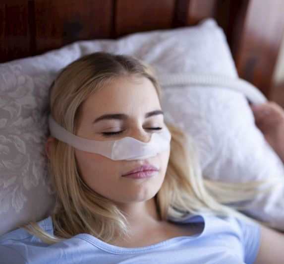 Sleep Apnea in Women: Overlooked Symptoms You Shouldn't Ignore 6 sleep apnea treatment in women โ woman wearing CPAP nasal mask while sleeping, effective OSA therapy