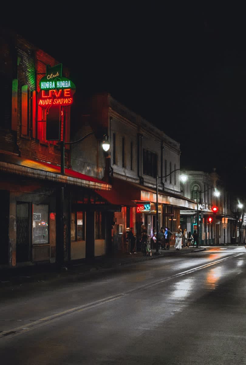 Honolulu Chinatown street at night with neon signs