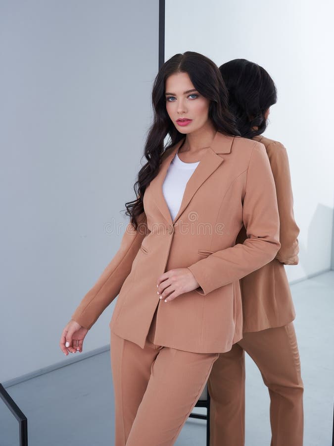 Classy woman in a beige tailored fashion look