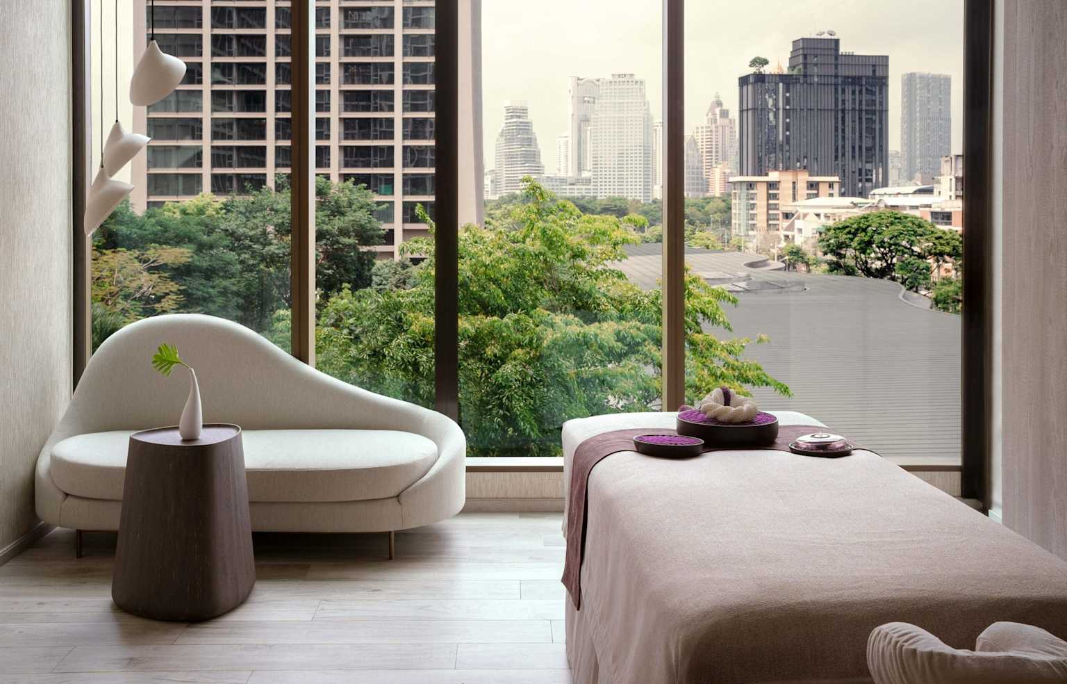Luxury Bangkok-style spa room with massage bed and warm ambient light