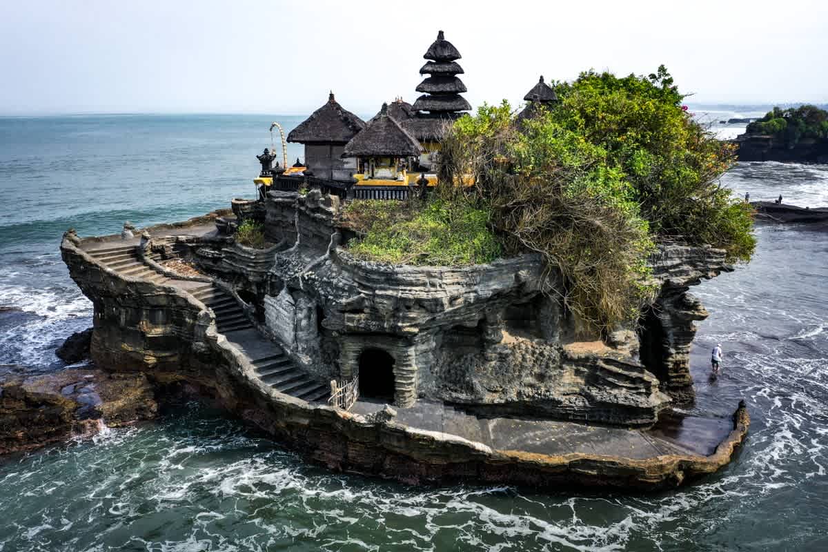 Tanah Lot temple on rocky island at sunset, Bali