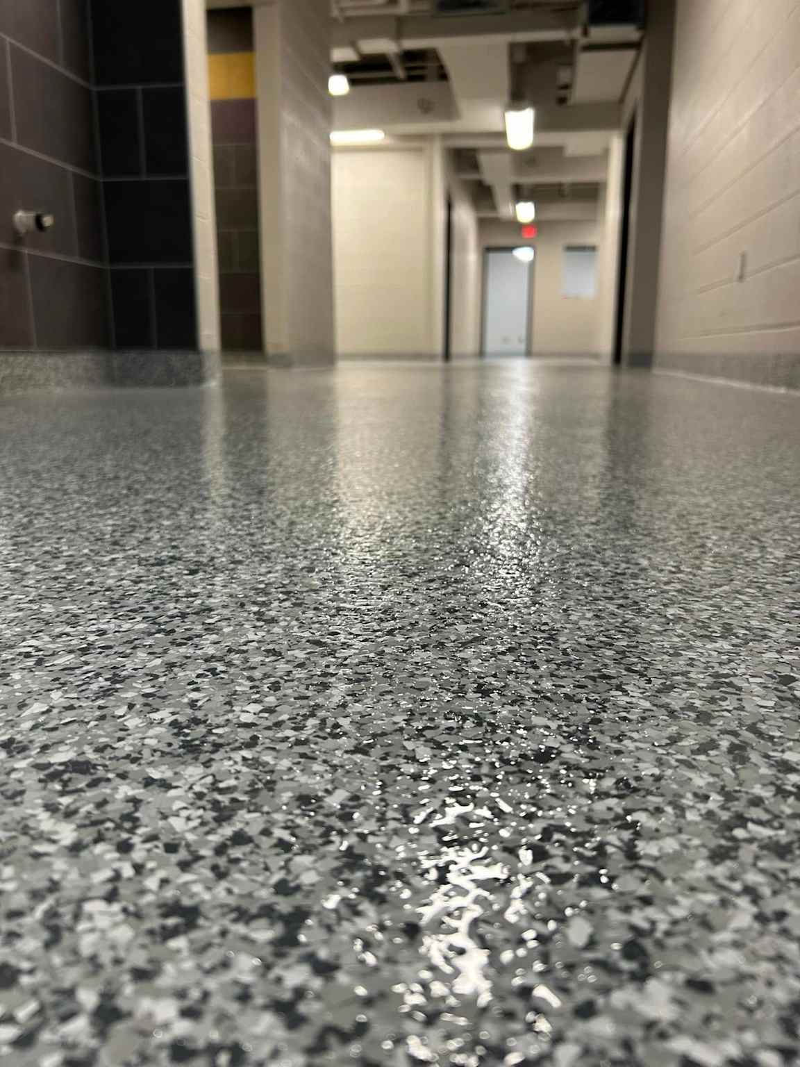 Polished epoxy resinous flooring in a commercial hallway