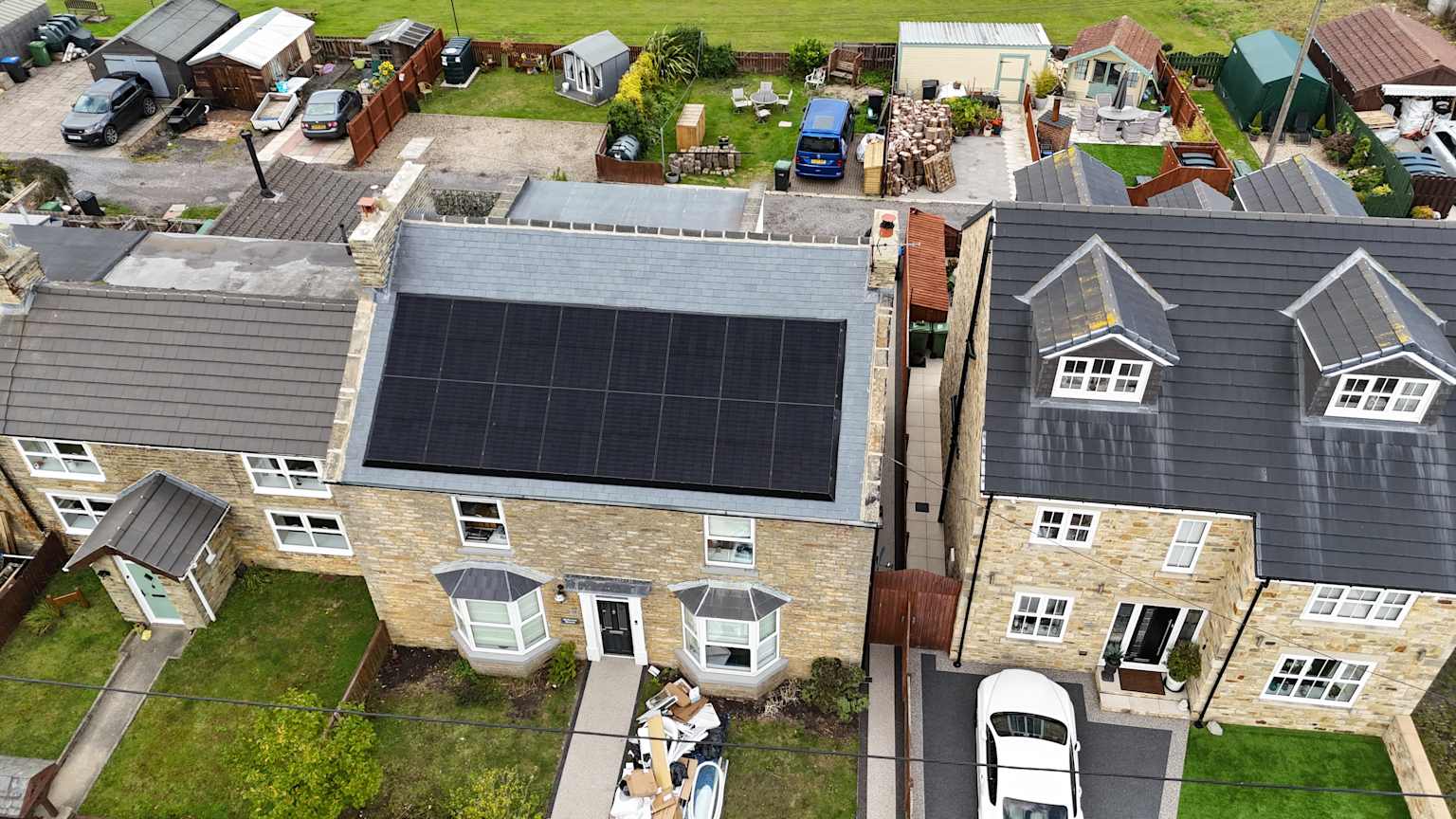 Aerial view of UK homes with solar panels used to show energy upgrade and property context