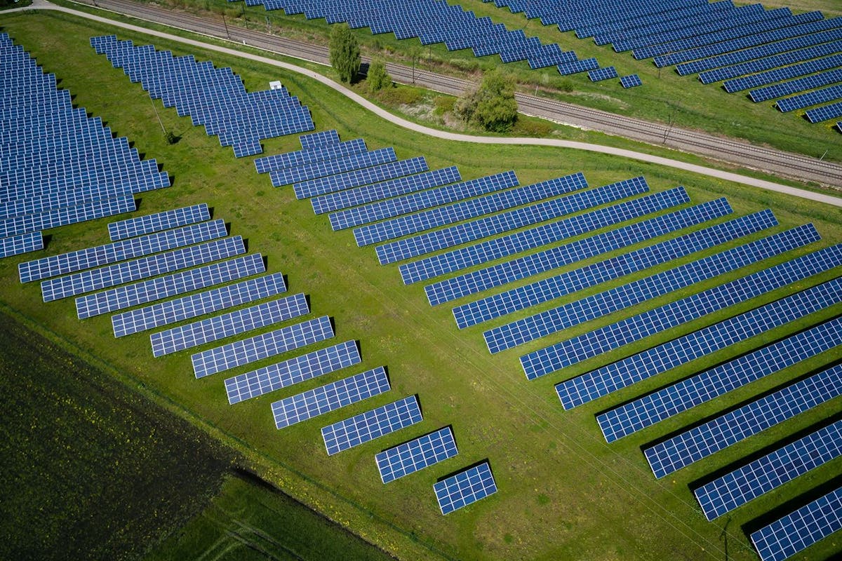 Large solar panel array with wind turbine — energy and infrastructure sector