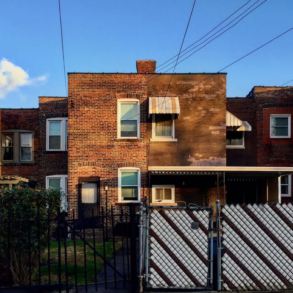 Row of brick row houses in a Pittsburgh neighborhood